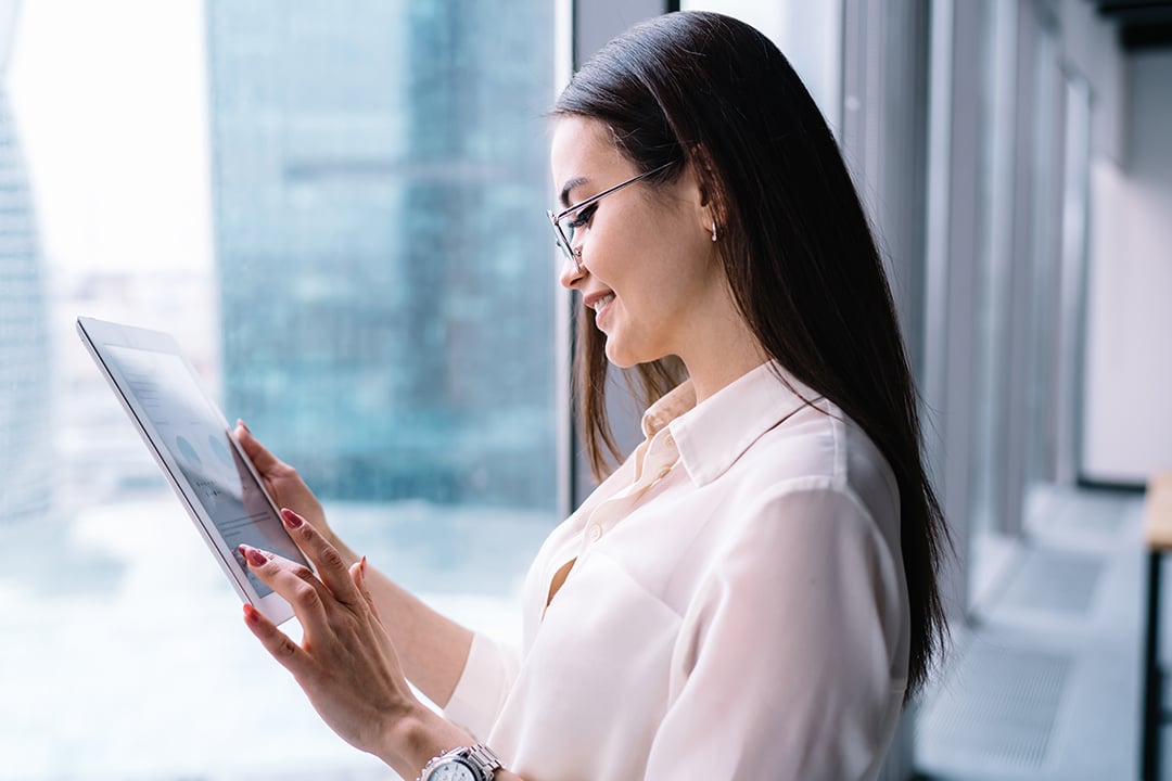 Business woman looking at a tablet in an office